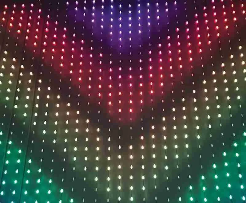 A curtain of colour-changing bulbs across a facade