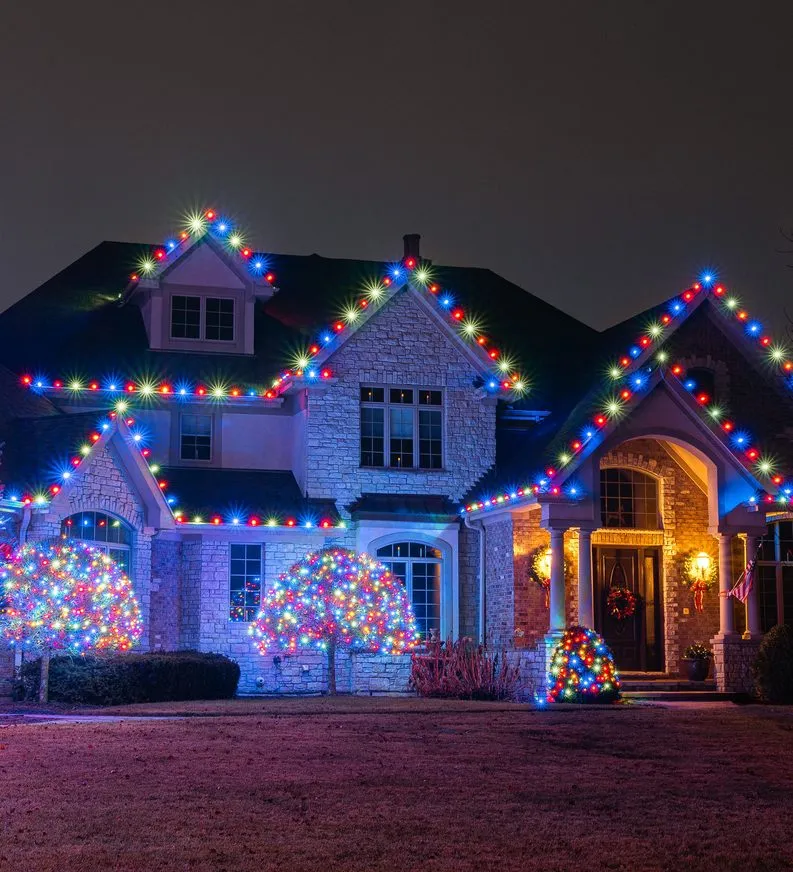 A stone house under multicolour roofline lights