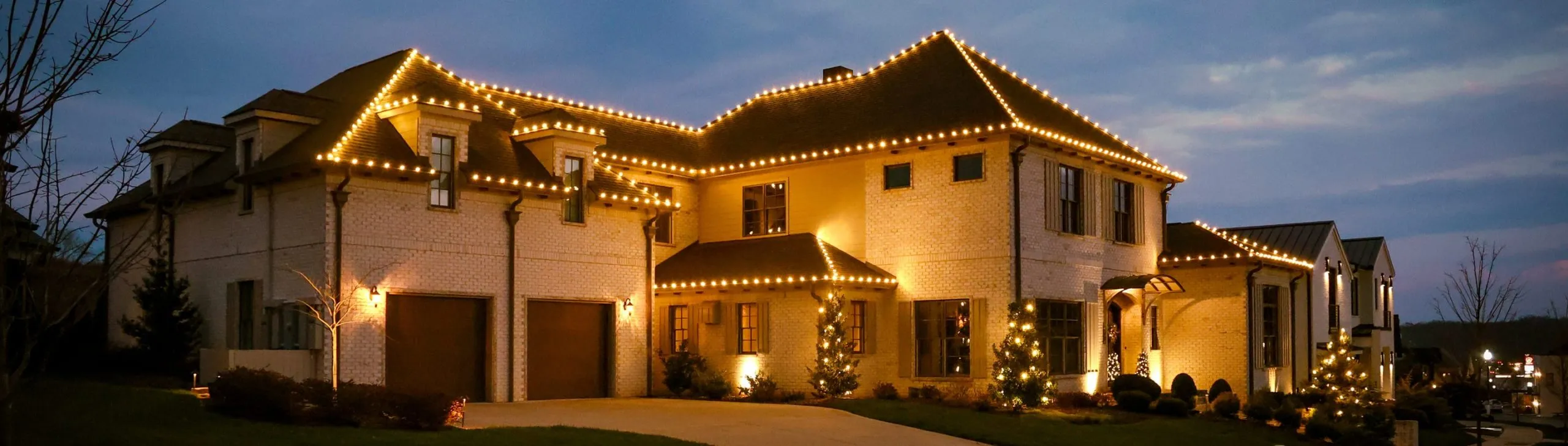 A house set up with permanent holiday lighting
