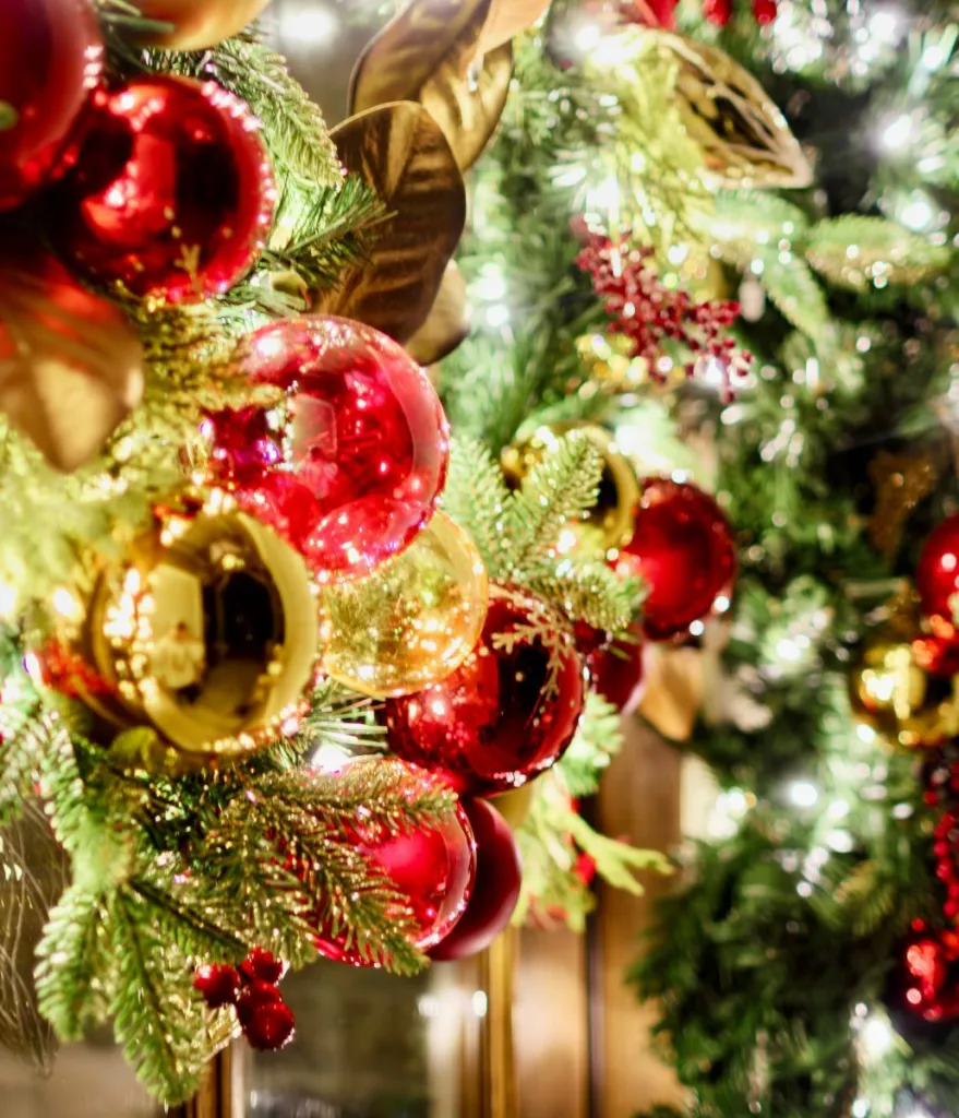 Red and gold baubles in a lit garland