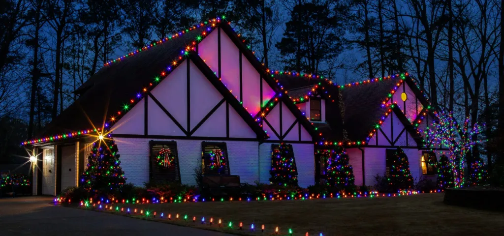 The same Tudor facade in multicolour holiday lighting