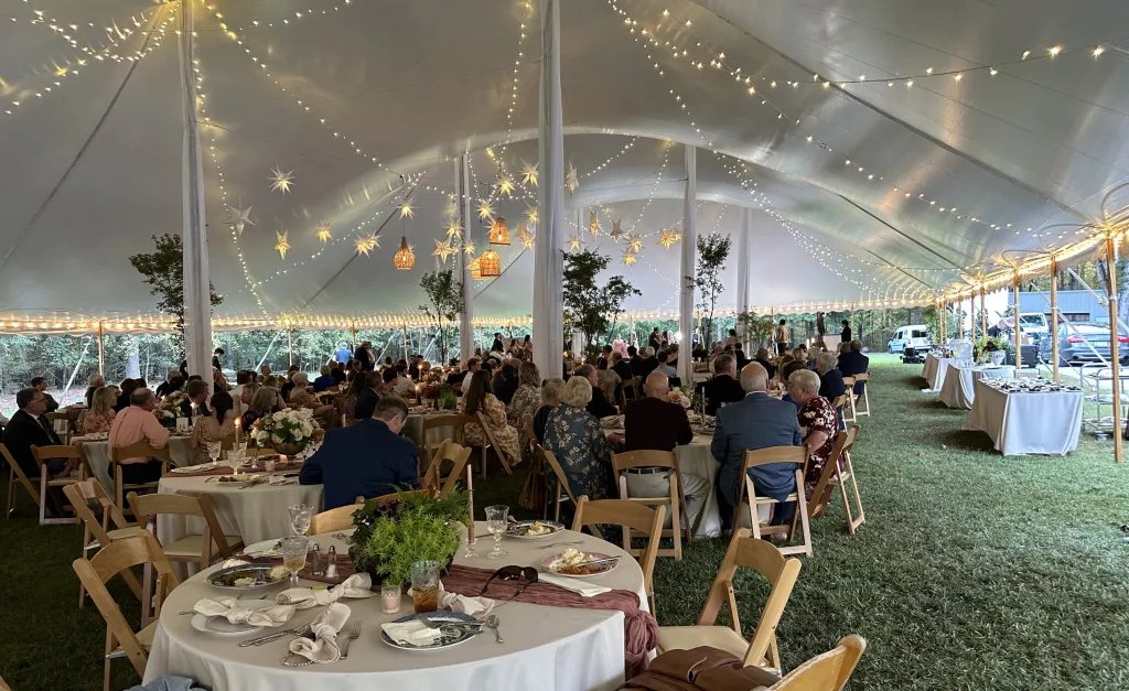The same reception tent under strung lighting